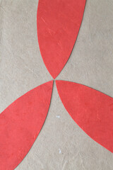 rounded red paper triangles on textured brown paper