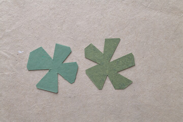 abstract green paper astral shapes on brown