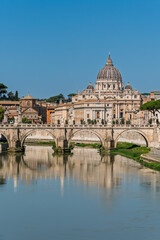 Italy - Rome - Tiber River - Tranquil reflections frame Sant'Angelo Bridge leading toward Vatican's iconic basilica