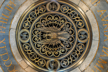 Naklejka premium Italy - Rome - Sant Agnese in Agone - Golden Pamphilj eagle emblem gleams on intricate marble floor with inscription