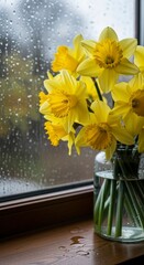 Bright yellow daffodils in vase on windowsill.
