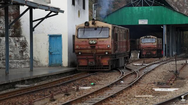 old diesel trains leaving on narrow gauge railway hill station rail yard