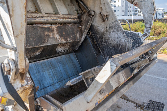rear loading hopper and hydraulic press of a waste collection vehicle.