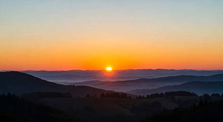 Obraz premium Sunset over mountain landscape with golden light reflecting on hills