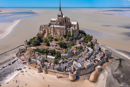 Aerial view with the spectacular Mont Saint Michel, rock island and cathedral, a famous landmark in Normandy France