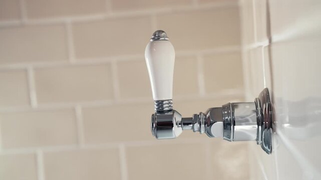 Woman turning on vintage shower faucet in retro style bathroom