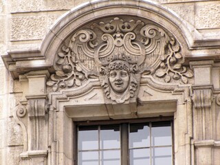 Obraz premium Architectural details of the Justizpalast in Munich, featuring Neo-Baroque ornaments, sculpted faces and figures designed by Friedrich von Thiersch in the late 19th century, DE, 17 Feb. 2011