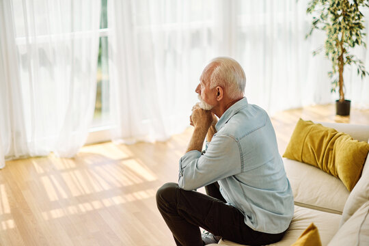 Portrait of a serious sad mature old man at home