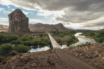 Bridge over Chubut River with Piedra Parada monolith. Patagonia, Argentina