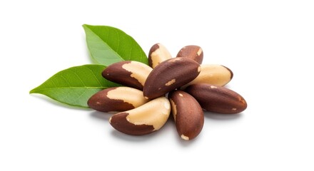 Obraz premium Close-up of Brazil nuts and green leaves on a white background