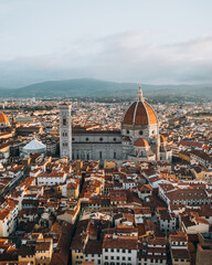 Obraz premium Aerial view of Florence featuring the iconic Duomo cathedral of Santa Maria del Fiore surrounded by the historic city center. Classic Tuscan architecture and Renaissance heritage captured from above