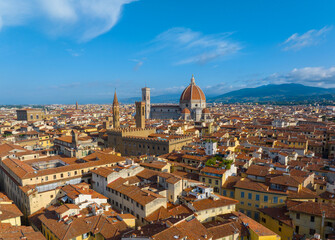 Obraz premium Aerial view of Florence city skyline featuring the iconic Duomo Cathedral of Santa Maria del Fiore under a clear blue summer sky, Tuscany, Italy