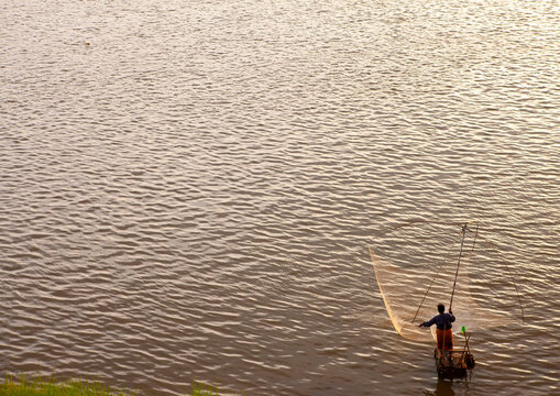 Fisherman with na net on Mekong river, Khammouane province, Thakhek, Laos