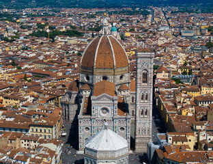 Fototapeta premium High angle aerial view of Florence with the Duomo Cathedral rising above terracotta rooftops on a bright summer day