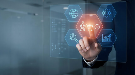 Fototapeta premium A professional hand interacts with a futuristic digital screen showing a customer experience journey icon in a modern bu