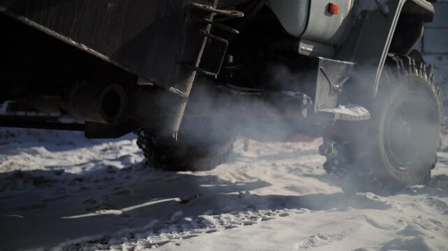 Construction truck exhaust emitting steam in winter conditions