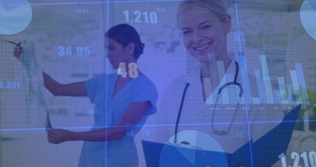 Viewing nurse in scrubs holding x-ray and Dr with stethoscope smiling, checking chart in clinic HUD