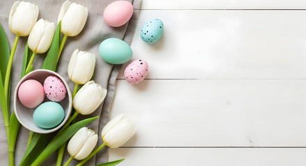 overhead Easter-themed flat-lay with white tulips, pastel Easter eggs in pink and turquoise, and gray linen on white wooden surface &mdash; ideal for holiday styling, spring d&eacute;cor, or Easter greeting visual