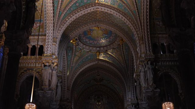 Ornate basilica nave with stained glass and chandeliers in Lyon