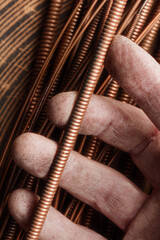 Strings of a musical instrument  on a male fingers. Close up detail of the string of an acoustic guitar, piano.