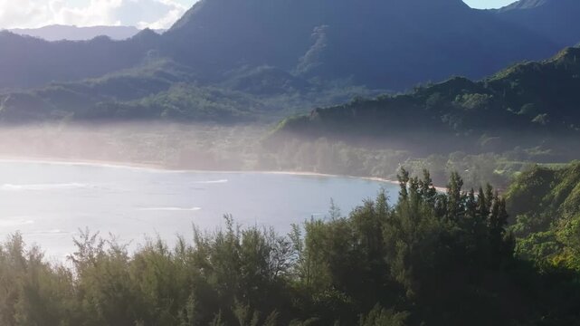 Scenic reveal of beautiful beach view and lush mountains, drone video, Kauai 4K