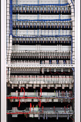 The reverse side of the electrical switchboard. The connected wires are tied with plastic ties.