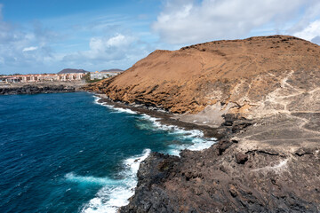Obraz premium Aerial view of yellow volcanic rock shoreline, Montaña Amarilla, Costa del Silencio, Tenerife