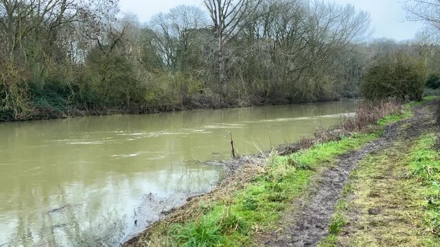 The Fast Flowing River at Nene Park on a grey and misty day, Nene Park, Peterborough, UK