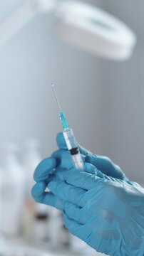The nurse medical beautician releases excess air from the syringe