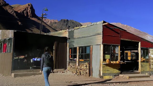 Female Traveler Approaching Local Store in Puente del Inca Village, Argentina - 4K