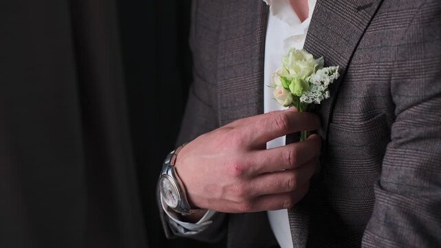 A groom with a boutonniere on his jacket