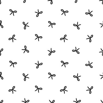 Minimalist seamless pattern with small black hand-drawn bows on a white background. Elegant coquette aesthetic for chic textile and decor.