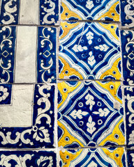 Blue and yellow Mexican Talavera ceramic tile pattern texture background