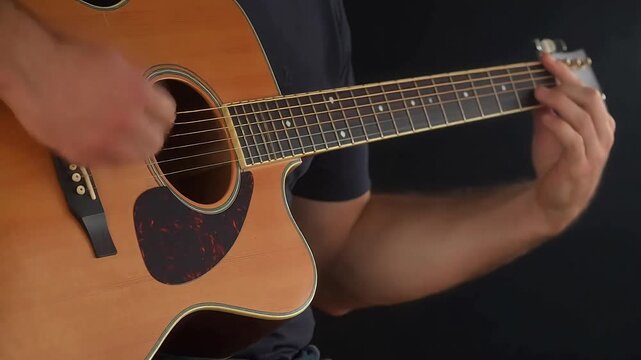 Person playing acoustic guitar
