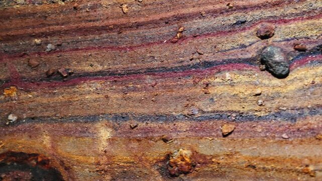 Rainbow Cave on Hormuz Island, Iran, showcasing naturally colorful rock formations and mineral layers. Unique geological landscape, natural wonder, travel destination, earth textures, vibrant colors, 