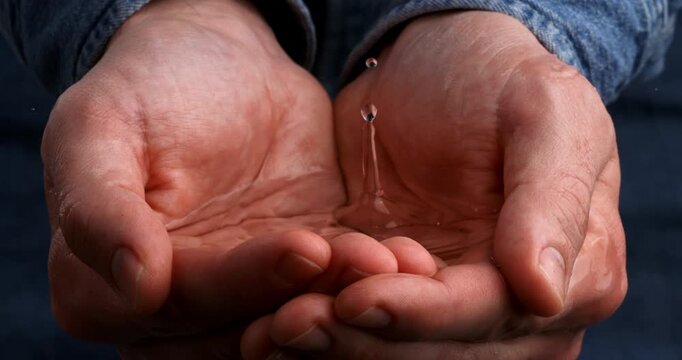  Slow Motion Clear Water Droplets Falling Into Open Human Hands On Black Background