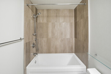 Bathroom with a white bathtub and a shower stall