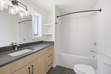 Bathroom with a white toilet, sink, and bathtub