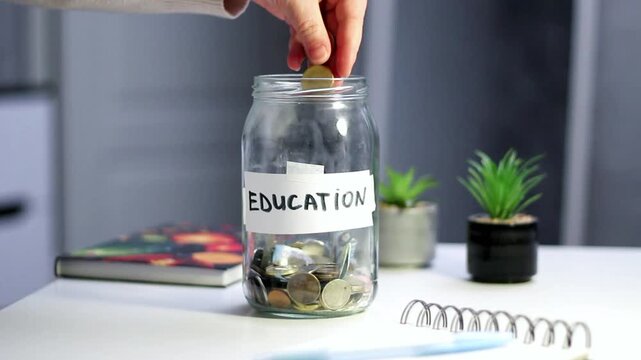 Saving for education fund using money jar. Young person carefully placing money into labeled Education savings jar. Perfect for student finance, parental planning, and investment in knowledge themes