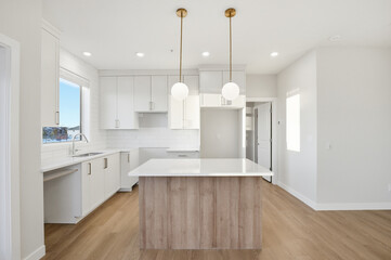 Kitchen with a white island and a white refrigerator