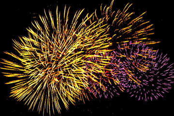 Fototapeta premium Colorful New Year fireworks on a black sky background