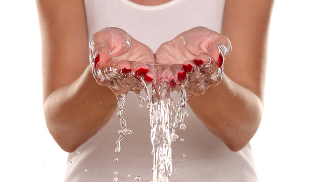 Studio shot of a woman&rsquo;s wet hands after washing, showing hygiene, cleanliness, and gentle daily care routine on white background.