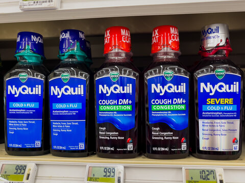 ATLANTA, GEORGIA - FEBRUARY 6, 2026 : Vicks NyQuil nasal congestion, cold and flu medicine bottles on a display shelf in an American pharmacy drugstore.