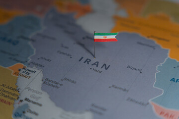 Iran flag pinned on political map over Iran in Middle East region © Rokas