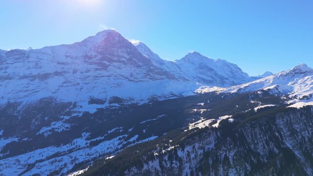 Eiger North Face, Monch and Jungfrau Mountains in Winter. Swiss Alps. Switzerland. Aerial View. Moving Backwards. View From Bussalp