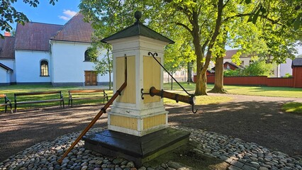 Sweden. A vintage water pump in the courtyard of the church. City of Vestervik. Kalmar County. © Andrii