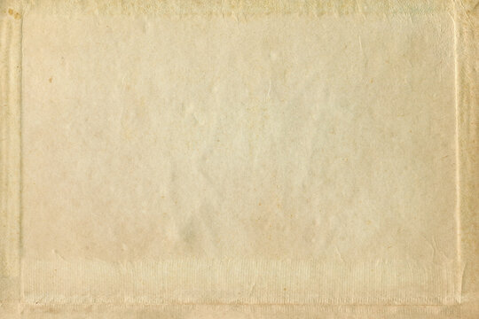 Old paper texture with vignette photo frame. Vintage antique sheet paper texture. Aged and yellowed paper background.