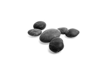 Fototapeta premium Black pebble stones arranged on a white background showcasing smooth textures and varying shapes, ideal for decorative or natural design purposes