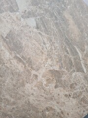 Obraz premium Close-up of a textured surface with a natural stone appearance. The surface features subtle patterns and variations in color, resembling marble or granite.