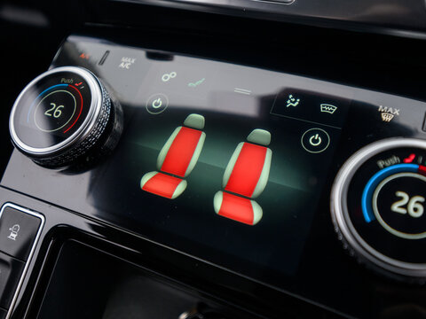 Heated seat controls on car climate control touchscreen and dials